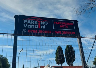 Cartello esterno Parking Vandini con scritta parcheggio auto e numeri di telefono